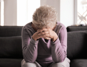 Loneliness image of a person holding head in hands